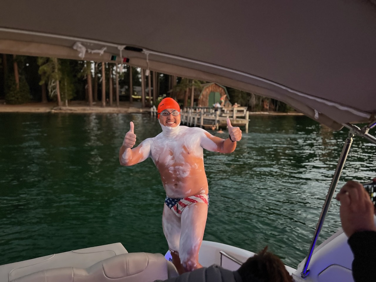 Robin Hipolito in an orange cap giving two thumbs up at the start of the Length swim on Lake Tahoe, August 2023.